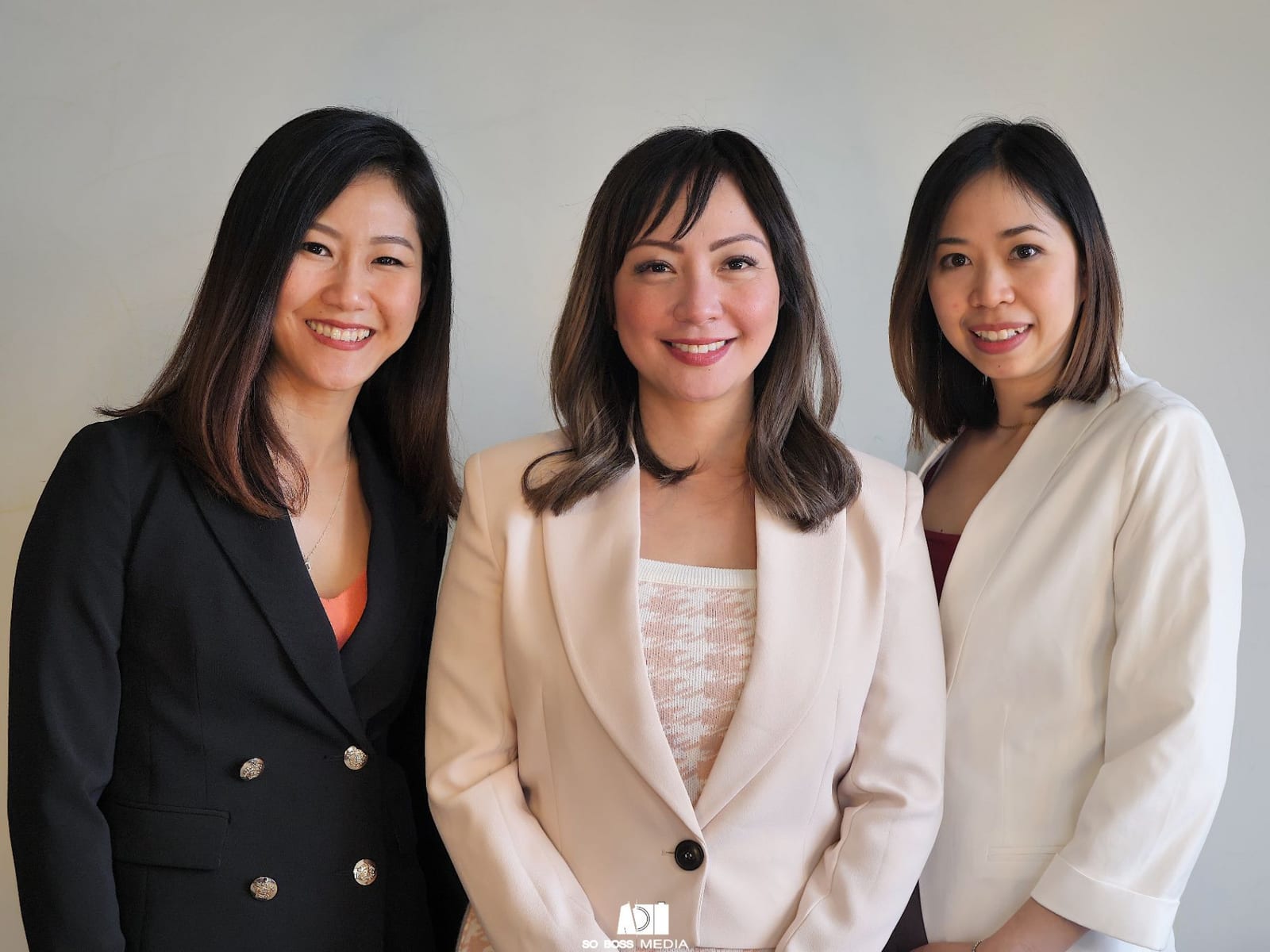 Corporate team portrait of three women in blazers at a Brisbane studio