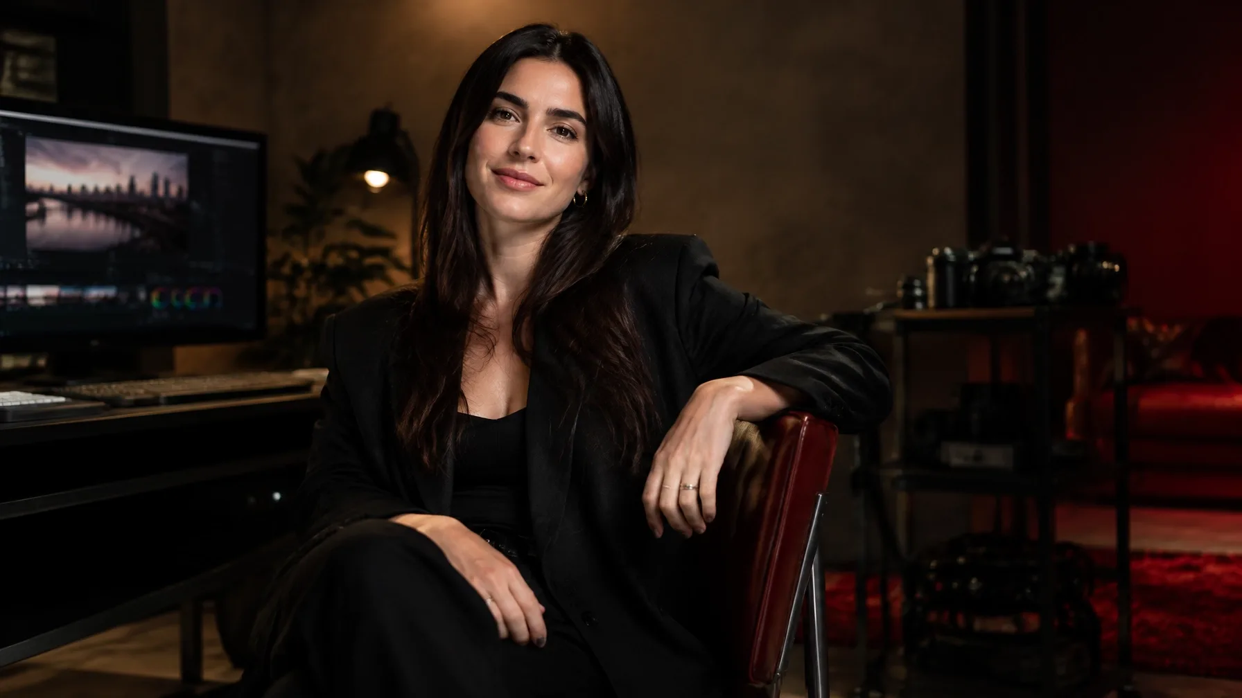 Creative professional posing naturally in a softly lit studio portrait