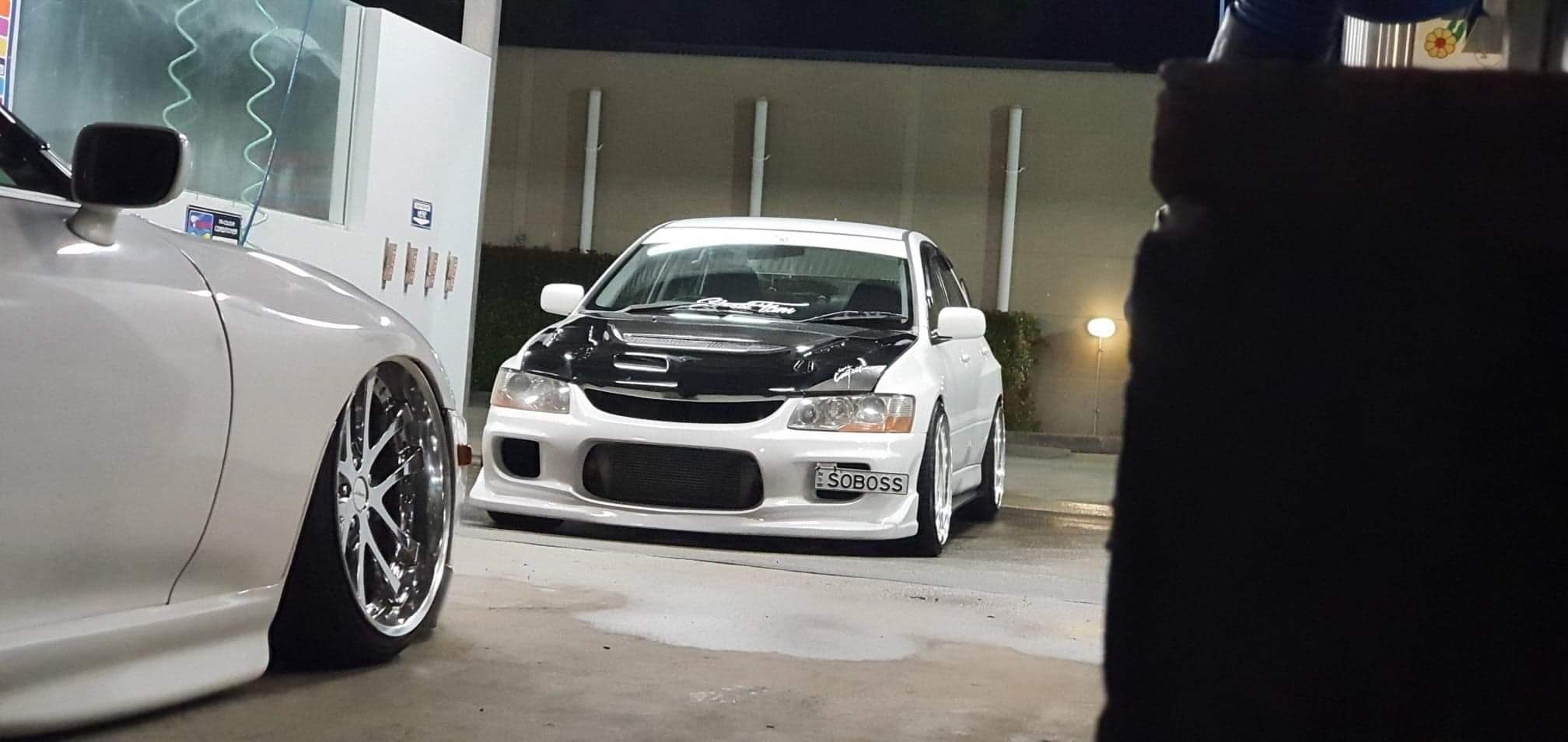 White Mitsubishi Evo photographed at a JDM car event